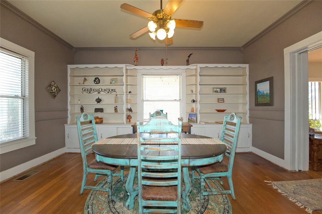 213 South Clements Street Gainesville, TX 76240 - Photo 5 of 37 a view of a dining room with furniture window and wooden floor