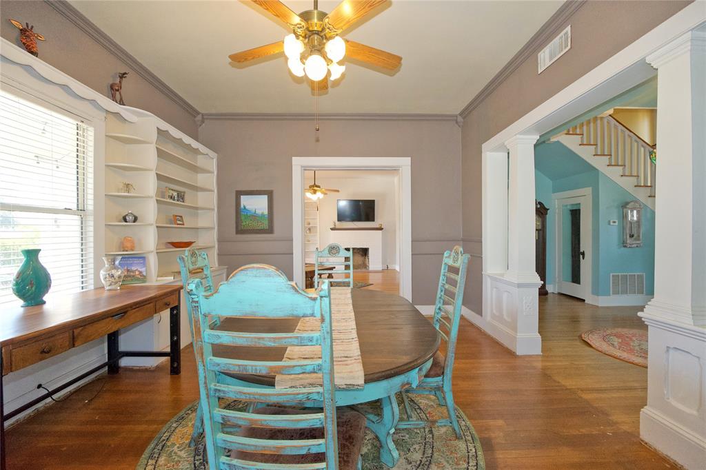 213 South Clements Street Gainesville, TX 76240 - Photo 6 of 37 a dining room with wooden floor and chandelier
