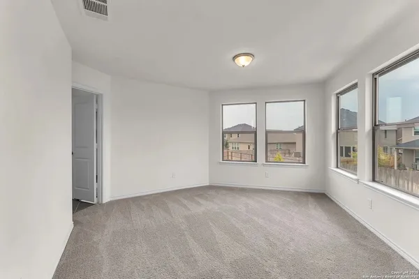 an empty room with windows and entrance