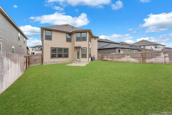 a view of a house with a yard and sitting area