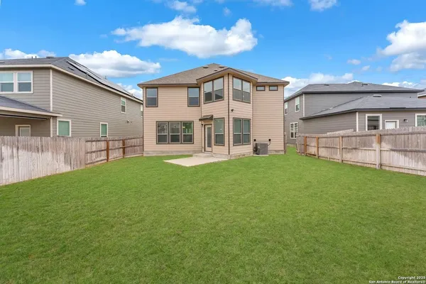 a front view of a house with a yard and outdoor seating