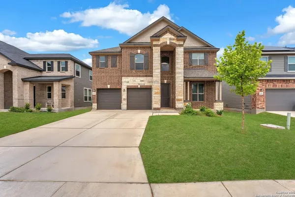 a front view of a house with a yard