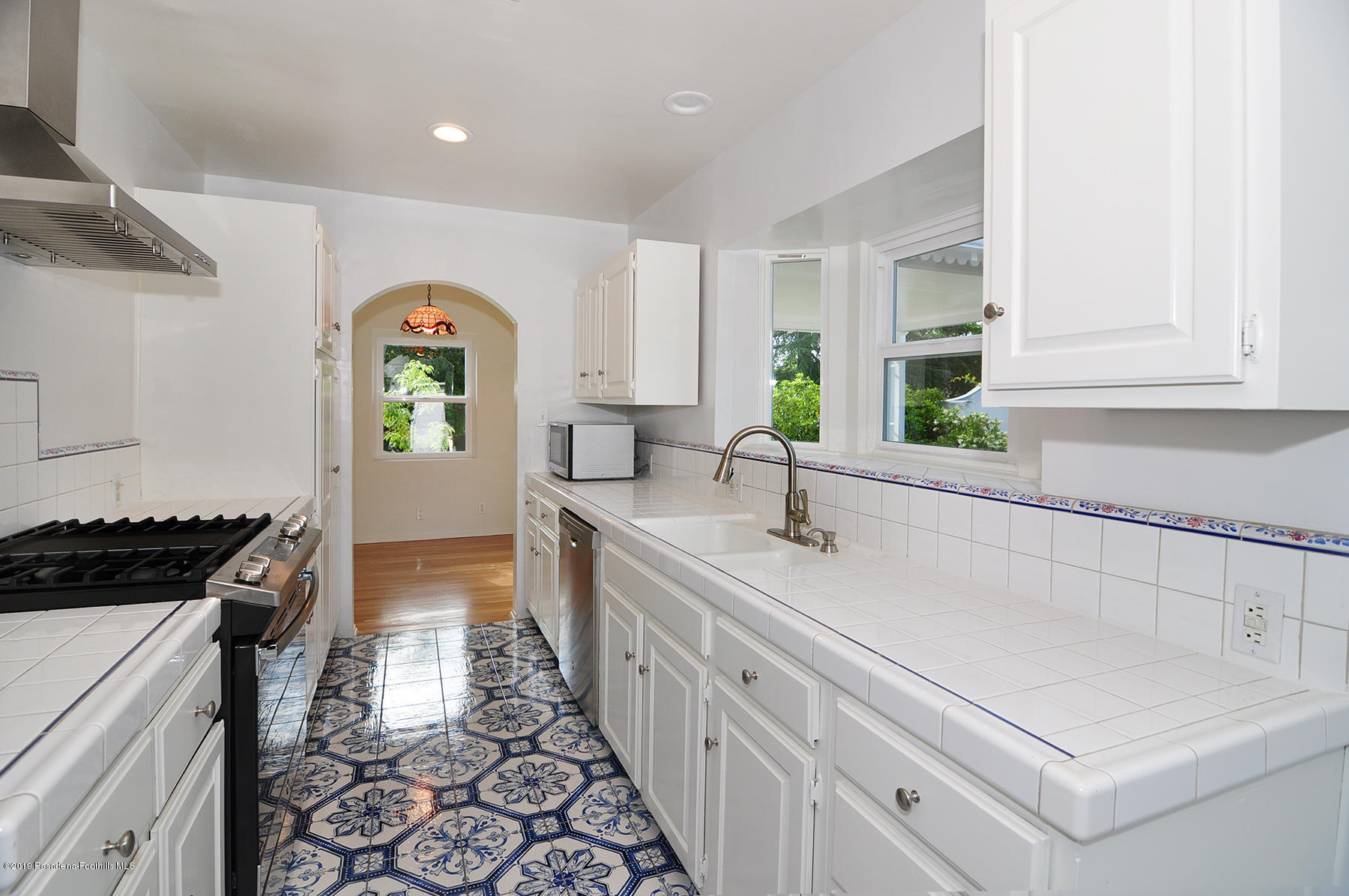 2011 Minoru Drive Altadena, CA 91001 - Photo 13 of 33 a kitchen with a sink a stove cabinets and a window