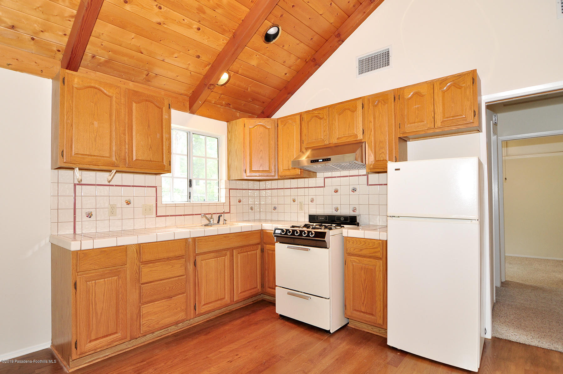 2011 Minoru Drive Altadena, CA 91001 - Photo 27 of 33 a kitchen with a white cabinets and white appliances