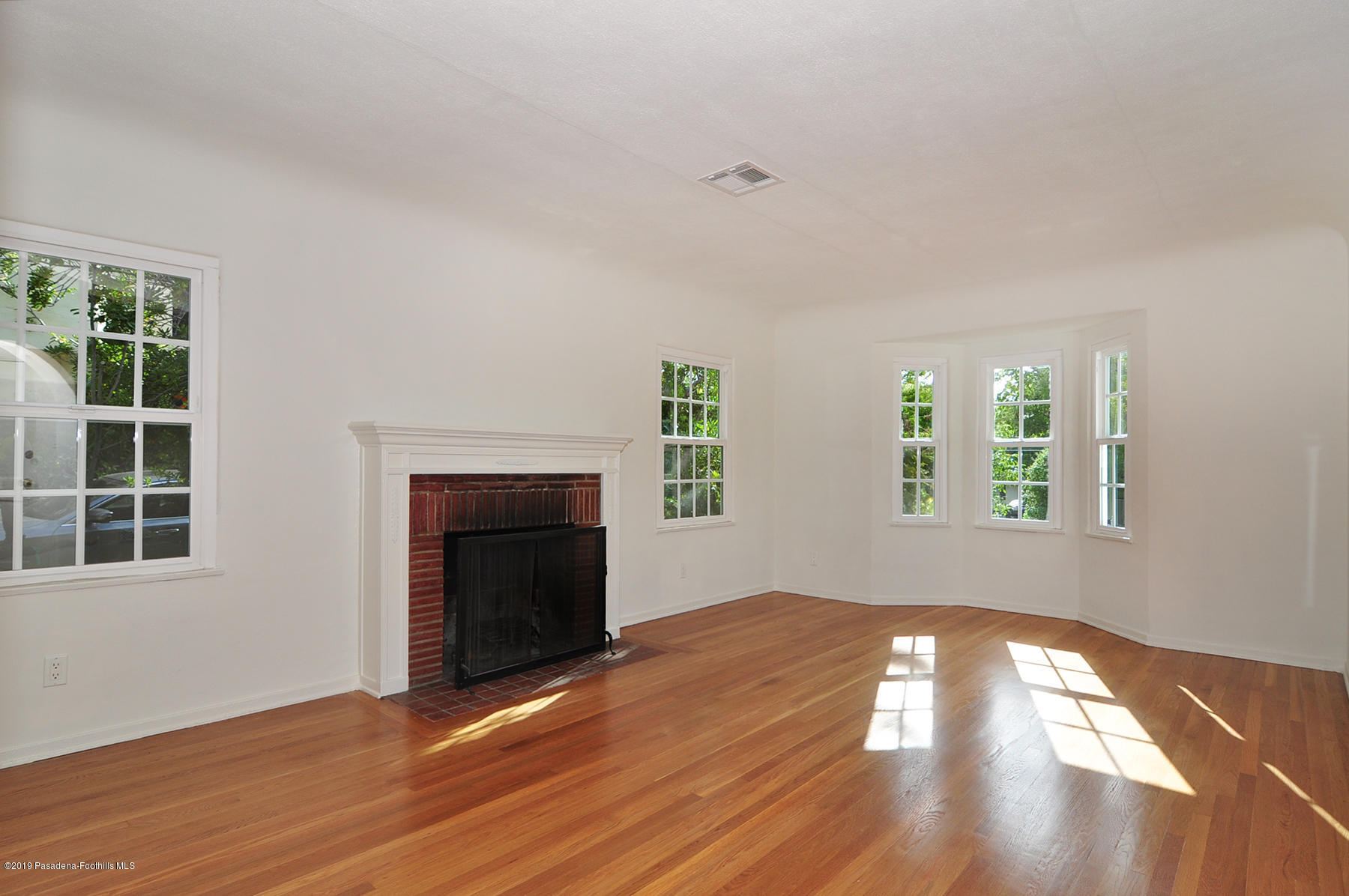 2011 Minoru Drive Altadena, CA 91001 - Photo 3 of 33 an empty room with windows and fireplace
