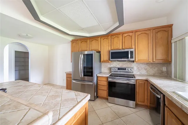 a kitchen with stainless steel appliances granite countertop a stove microwave and refrigerator