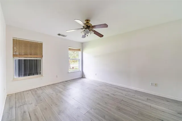 wooden floor in an empty room with a window