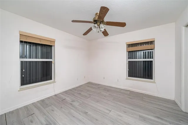 a view of a ceiling fan and wooden floor