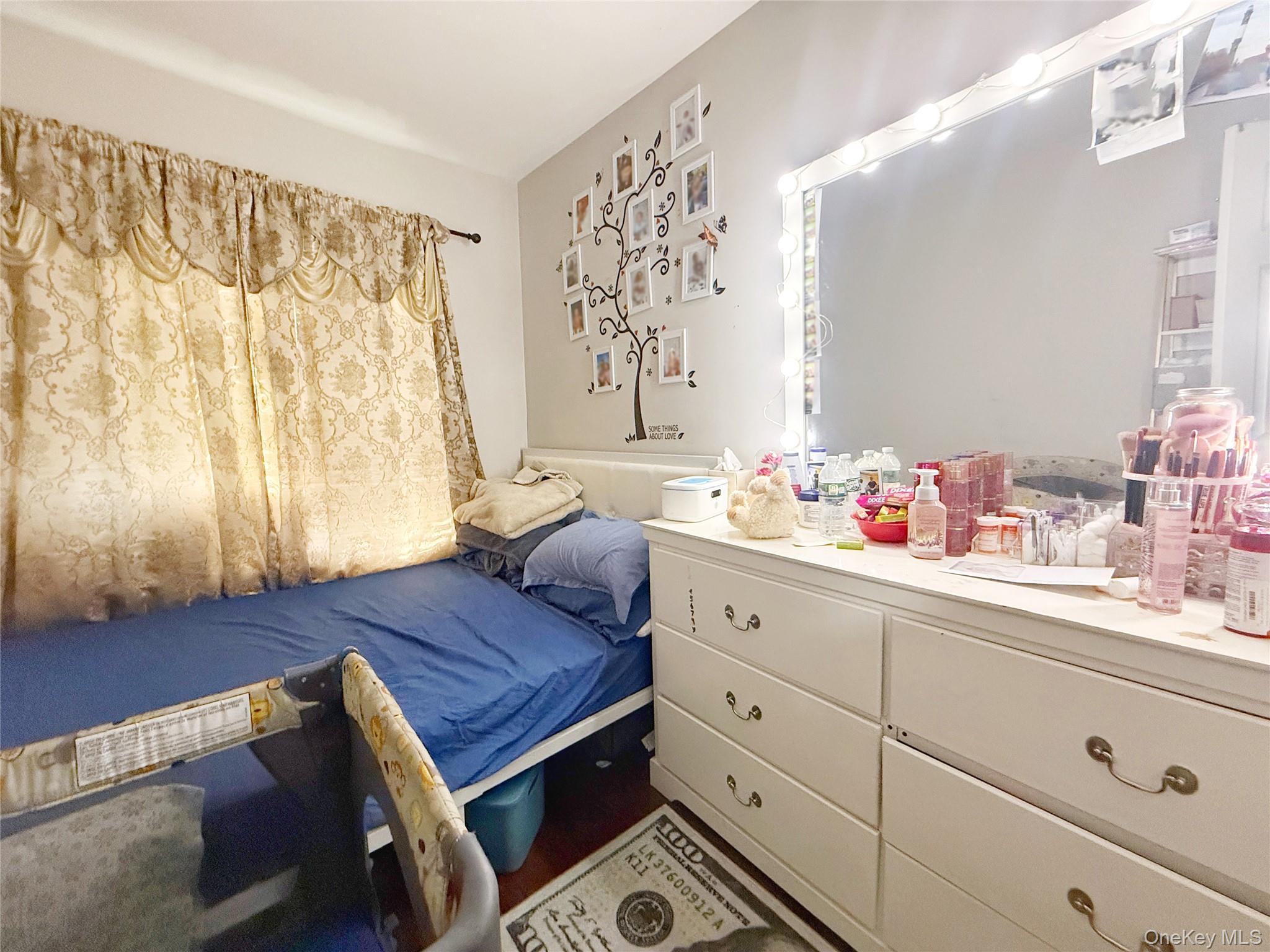 110-39 156th Street Queens, NY 11433 - Photo 11 of 27 a living room with furniture and a dresser