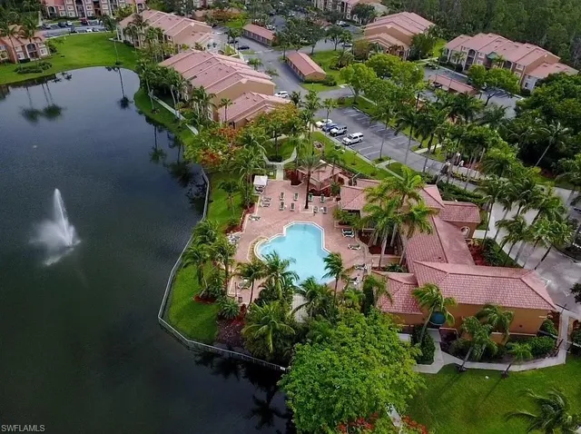 an aerial view of a house with garden space and lake view