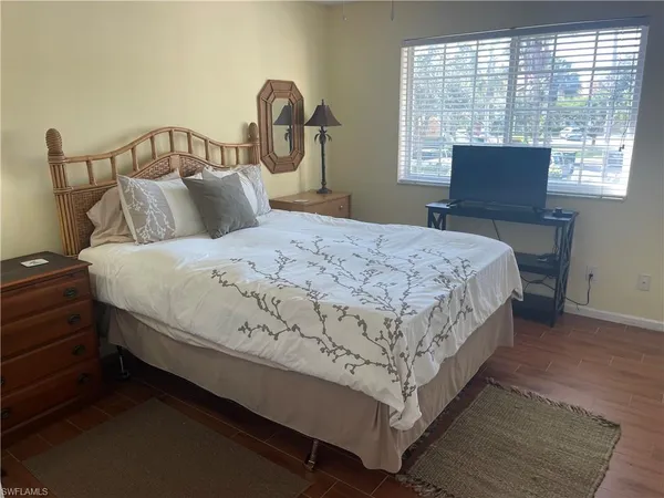 a bedroom with a bed and window