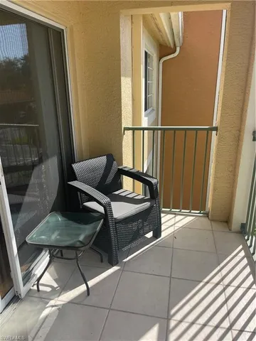 a room with furniture pool table and windows