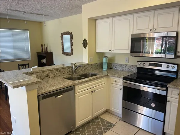 a kitchen with a sink stove and microwave