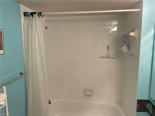 a bathroom with a shower and a bath tub