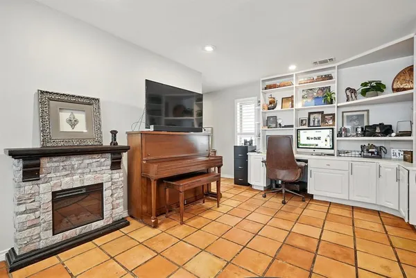 a living room with furniture a flat screen tv and a fireplace