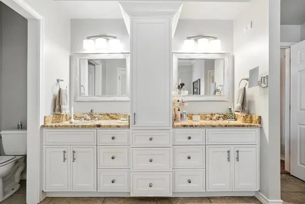 a spacious bathroom with a tub shower and windows