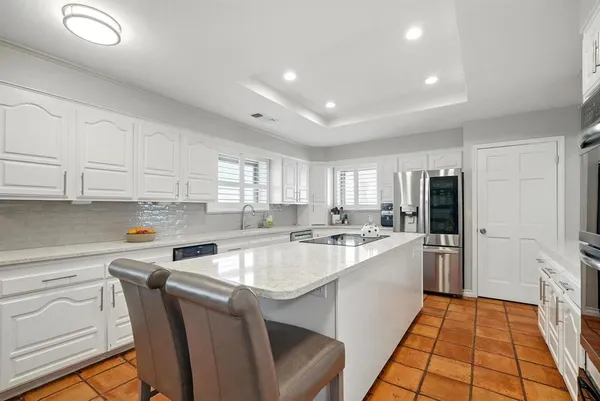 a kitchen with a sink a stove cabinets and refrigerator