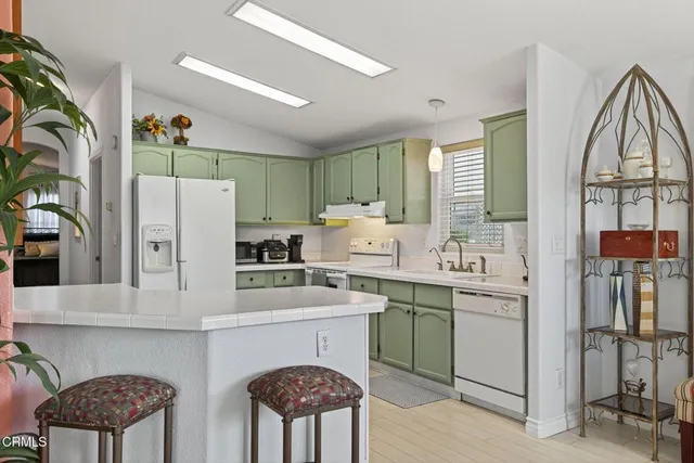 a kitchen that has a sink and a stove in it