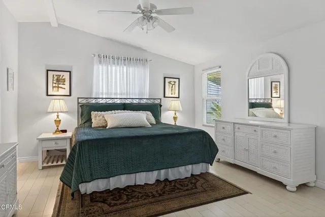 a bedroom with a bed and a flat tv screen on wall