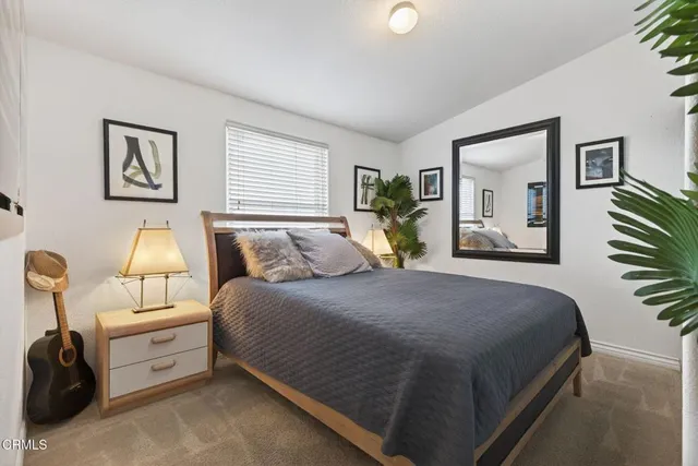 a bedroom with a large bed and a lamp