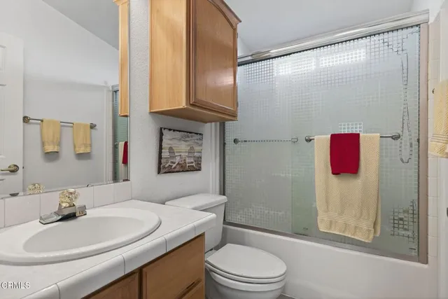 a front view of a house with outdoor seating and lots of potted plants