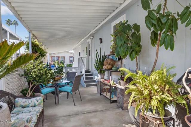 a view of yard from deck with patio