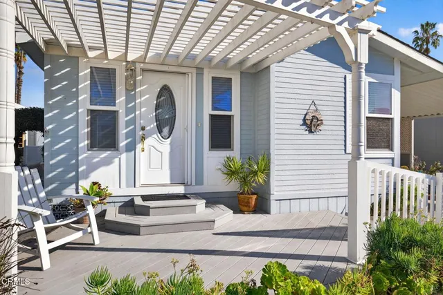 a view of a patio with table and chairs potted plants