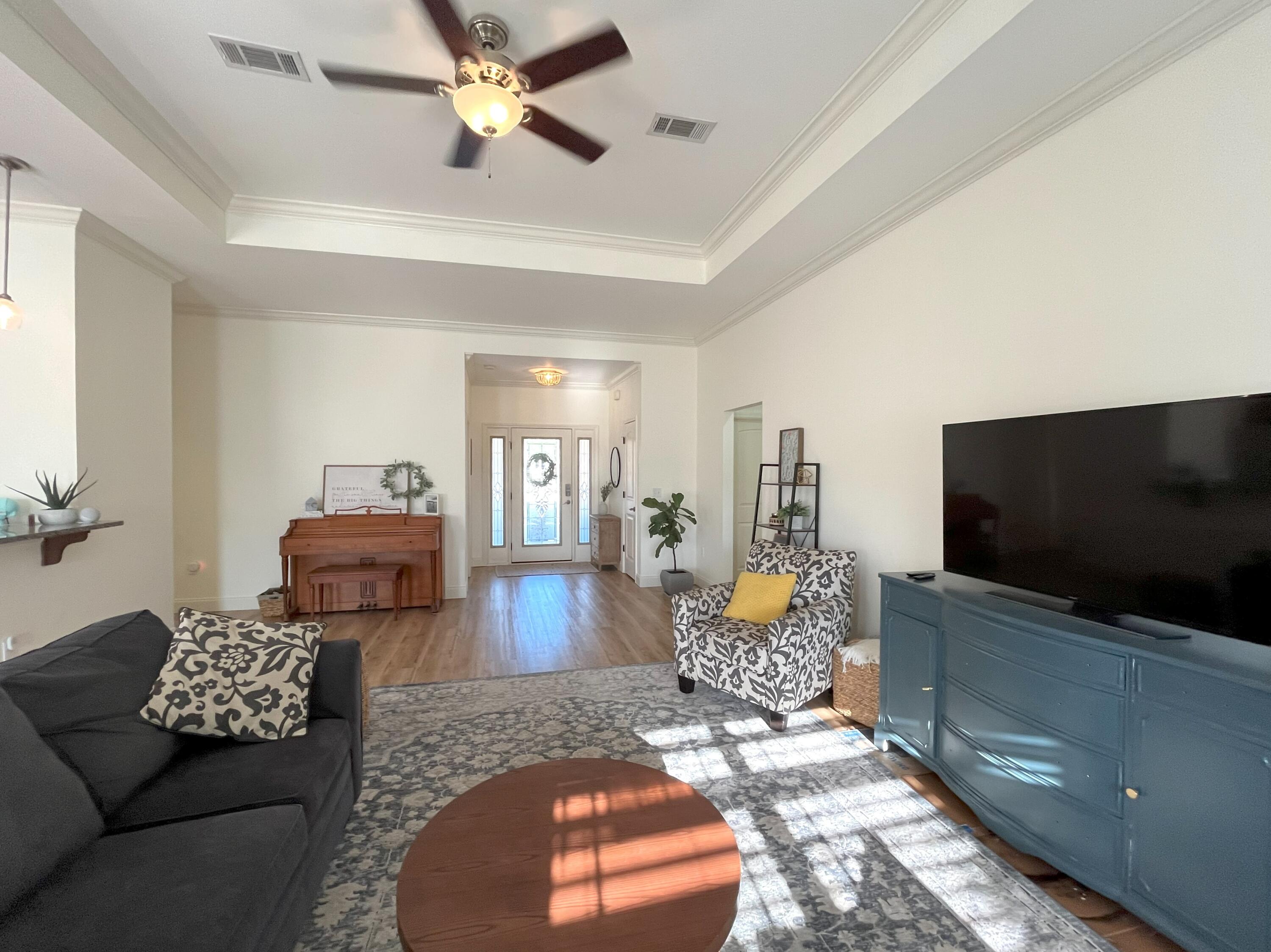 4589 Hermosa Road Crestview, FL 32539 - Photo 4 of 34 a living room with furniture and a flat screen tv