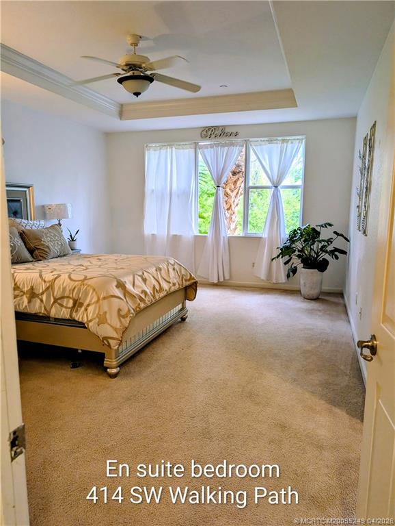 414 Southwest Walking Path, Unit 414 Stuart, FL 34997 - Photo 5 of 15 a spacious bedroom with a bed and a large window