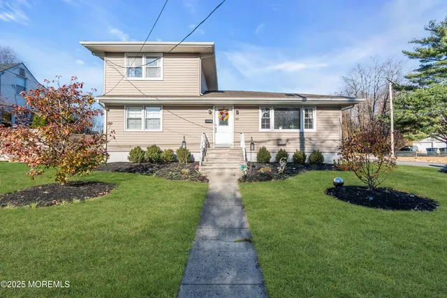 a front view of a house with a yard