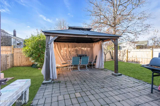 a view of house with backyard and outdoor seating