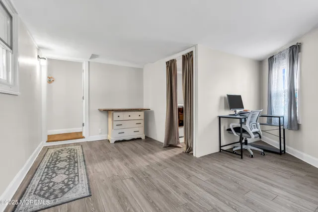 a view of room with furniture and wooden floor