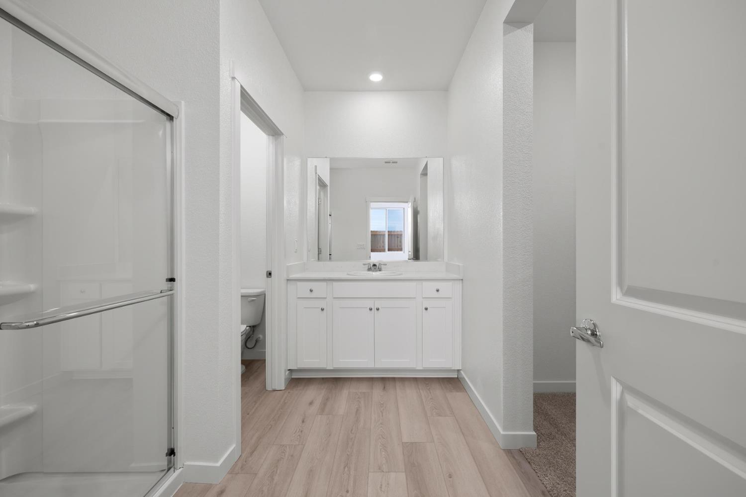 809 Chatham Lane Patterson, CA 95363 - Photo 11 of 16 a bathroom with a sink a mirror and a shower