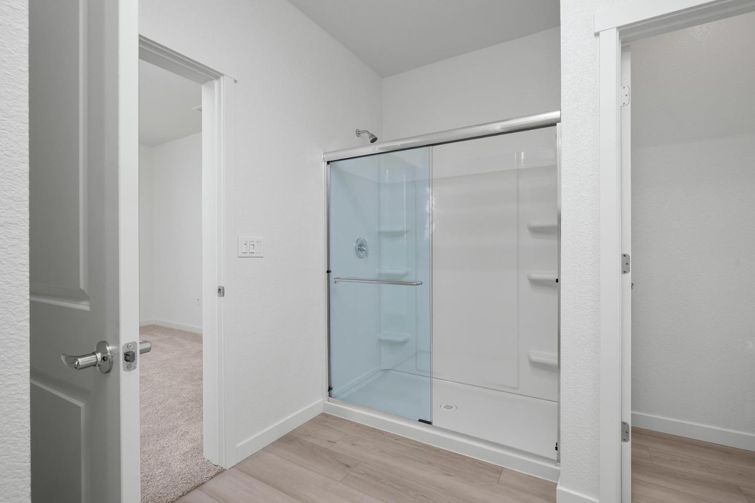 809 Chatham Lane Patterson, CA 95363 - Photo 12 of 16 a bathroom with a glass shower door