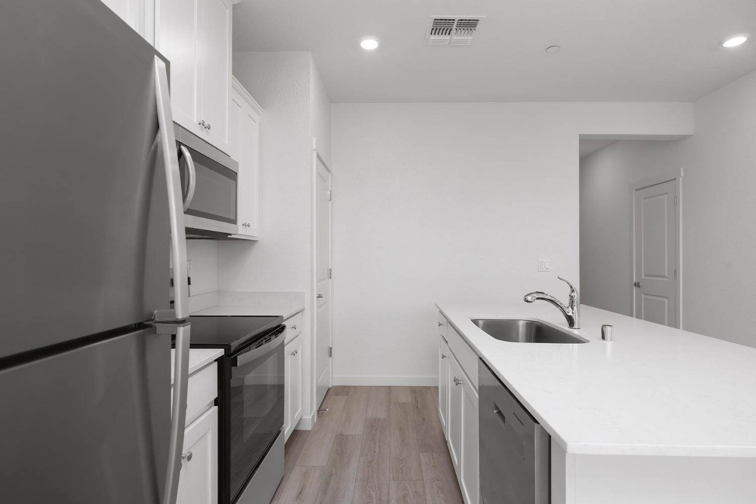 809 Chatham Lane Patterson, CA 95363 - Photo 4 of 16 a kitchen with a sink and a refrigerator