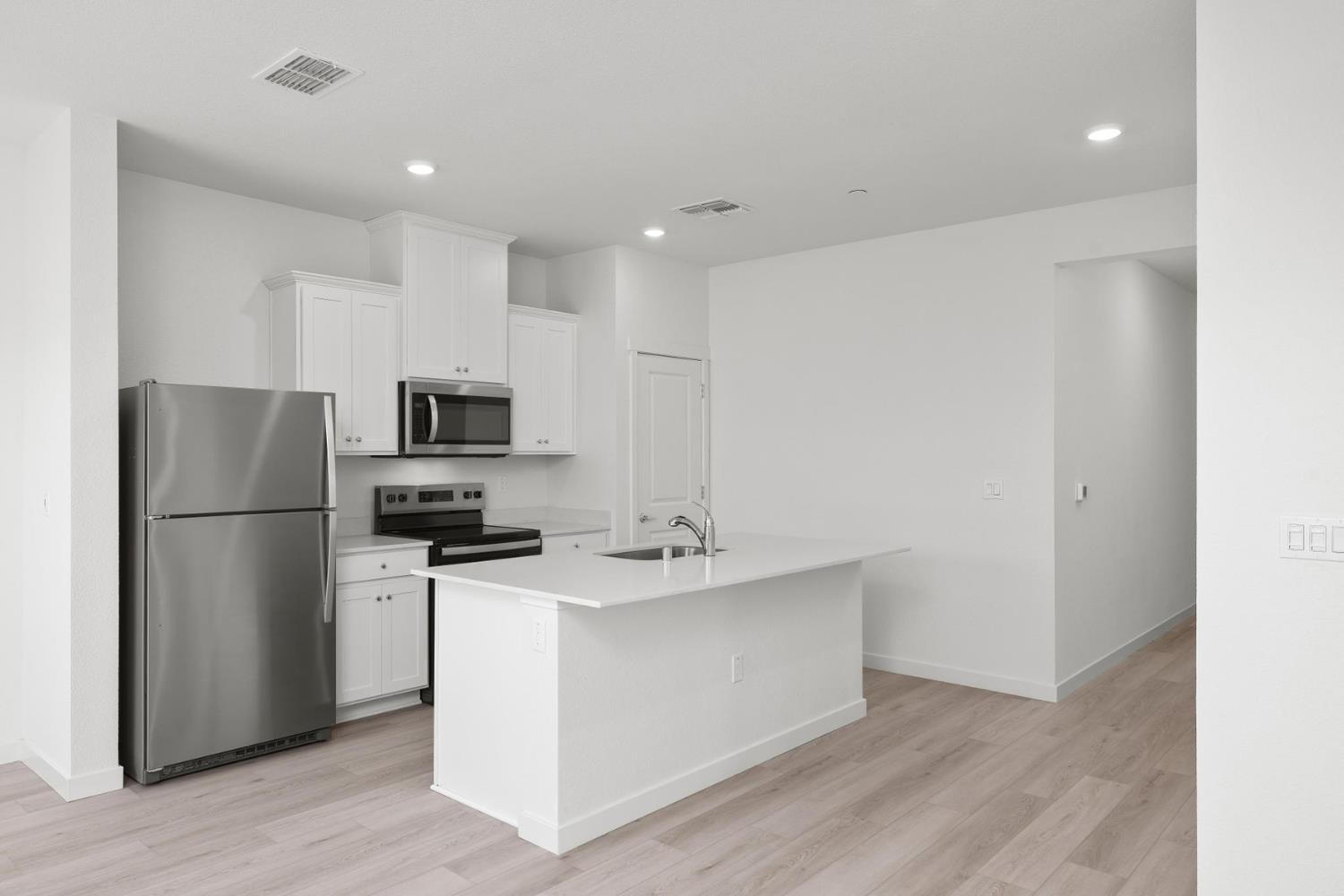 809 Chatham Lane Patterson, CA 95363 - Photo 5 of 16 a kitchen with stainless steel appliances a refrigerator stove microwave and sink