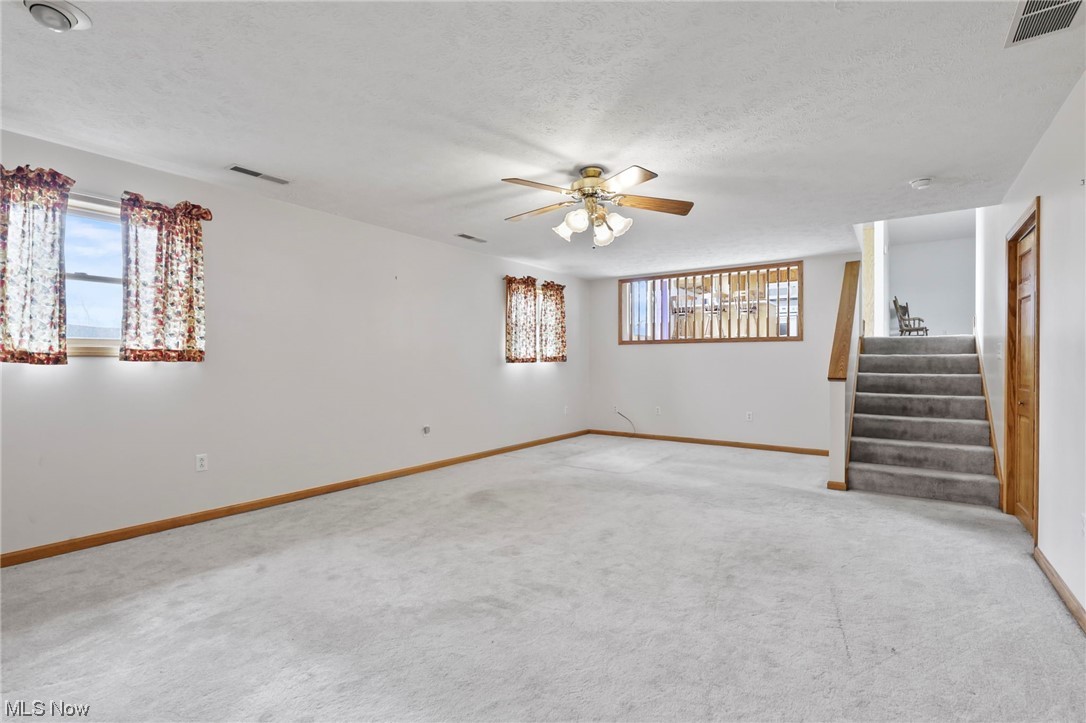 411 Adario West Road Shiloh, OH 44878 - Photo 14 of 35 Basement with ceiling fan, light colored carpet, and a textured ceiling