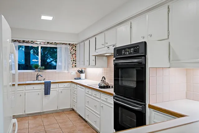 a kitchen with stainless steel appliances a stove sink and cabinets
