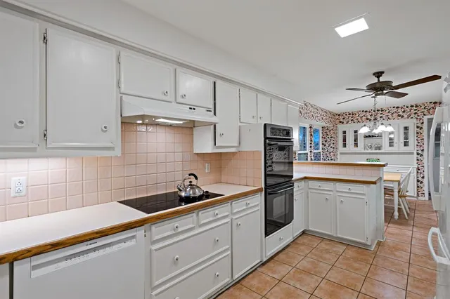 a kitchen with stainless steel appliances granite countertop a sink and cabinets
