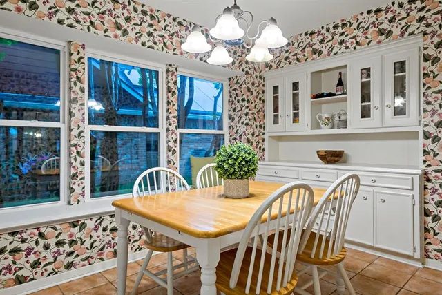 a view of a dining room with furniture and chandelier