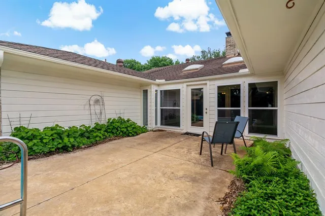 a view of a house with backyard and sitting area
