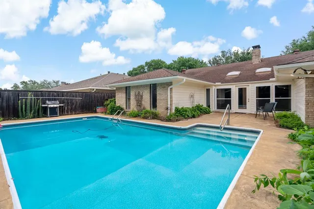 a view of house with swimming pool having outdoor seating