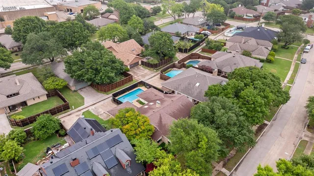 an aerial view of residential houses with outdoor space