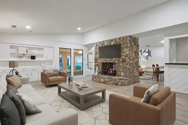 a living room with fireplace furniture and a fireplace