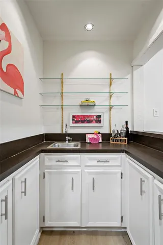 a kitchen with granite countertop a sink and cabinets