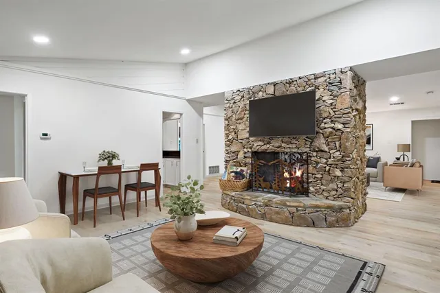 a living room with fireplace furniture and a flat screen tv