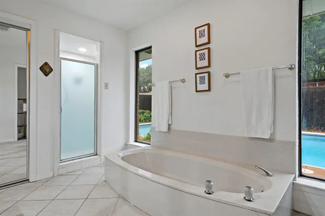 a bathroom with a bathtub and shower