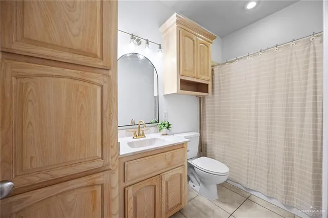 a bathroom with a toilet a sink and a mirror