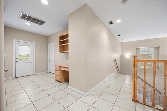 a view of a refrigerator in kitchen and entryway