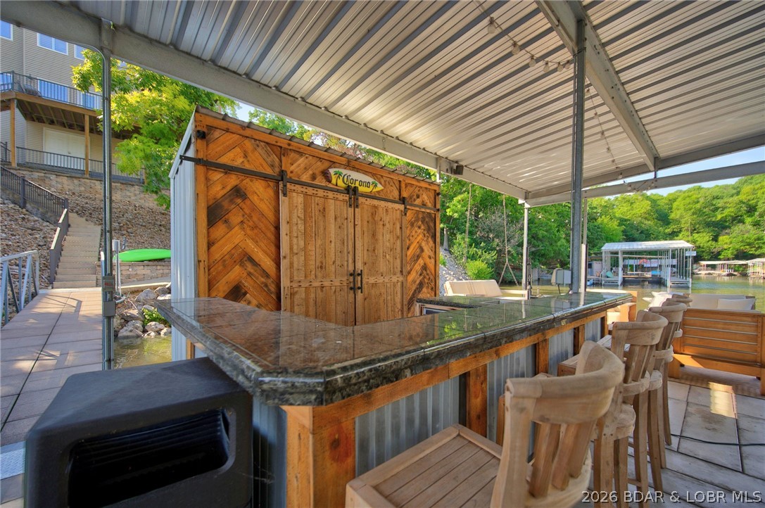 51 Arrowhead Beach Road Lake Ozark, MO 65049 - Photo 55 of 68 Bar and storage with refiridge, ice maker and micr